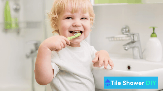 Boy Brushing Teeth at Bathroom Sink